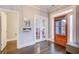 Inviting entryway with hardwood floors, a decorative mirror, and elegant french doors to another room at 401 Night Hawk Ct, Canton, GA 30114