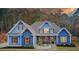 Charming blue home with craftsman-style details, a stone porch, and manicured landscaping at 401 Night Hawk Ct, Canton, GA 30114