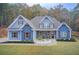 Charming blue two-story home with wooden shutters and a professionally landscaped yard at 401 Night Hawk Ct, Canton, GA 30114