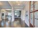 A view of the home's foyer with gleaming wood floors and a glimpse into other rooms at 401 Night Hawk Ct, Canton, GA 30114