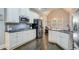 Open kitchen featuring stainless steel appliances, granite countertops and dark hardwood floors at 401 Night Hawk Ct, Canton, GA 30114