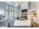 Bright living room with high ceilings, large windows, stone fireplace, and a comfortable sectional sofa at 401 Night Hawk Ct, Canton, GA 30114
