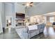 Inviting living room featuring a stone fireplace, built-in shelving, and hardwood floors at 401 Night Hawk Ct, Canton, GA 30114
