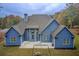 Picturesque rear exterior featuring a patio area and swing set, all set against a backdrop of lush greenery at 401 Night Hawk Ct, Canton, GA 30114