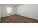 This cozy bedroom features neutral walls, a plush carpet, and a bright window at 4940 Elm Brook Dr, Atlanta, GA 30349