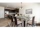 Bright dining area with glass table, stylish chairs, and an open view to the modern kitchen at 4940 Elm Brook Dr, Atlanta, GA 30349