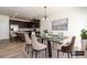 Elegant dining room adjacent to the kitchen, featuring a glass table and stylish chairs at 4940 Elm Brook Dr, Atlanta, GA 30349
