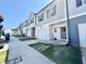 A row of townhomes featuring garages, welcoming front doors and manicured front lawns at 4940 Elm Brook Dr, Atlanta, GA 30349