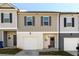 Attractive townhomes with gray siding, shuttered windows, one-car garages and neatly kept lawns at 4940 Elm Brook Dr, Atlanta, GA 30349
