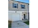 Charming townhome featuring a one-car garage and gray siding with complementary blue shutters at 4940 Elm Brook Dr, Atlanta, GA 30349