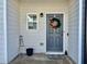 Cozy porch with a decorated gray door and a small 'HOME' sign adding a personal touch at 4940 Elm Brook Dr, Atlanta, GA 30349