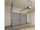 Garage interior showing door mechanics and a gray sectional door at 4940 Elm Brook Dr, Atlanta, GA 30349