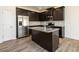 Kitchen boasts granite countertops, a kitchen island with a sink, and stainless steel appliances, complemented by dark cabinetry at 4940 Elm Brook Dr, Atlanta, GA 30349