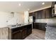 Spacious kitchen featuring an island with a sink, granite countertops, and stainless steel appliances at 4940 Elm Brook Dr, Atlanta, GA 30349