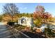 Stone sign at the entrance to Highly Grove, surrounded by trees with fall colors at 4940 Elm Brook Dr, Atlanta, GA 30349