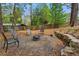 Backyard featuring a fire pit area with stone accents and seating for outdoor gatherings at 1155 Moores Mill Nw Rd, Atlanta, GA 30327