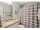 Bathroom featuring a marble countertop vanity, a toilet, and a shower with a gray and white striped curtain at 1155 Moores Mill Nw Rd, Atlanta, GA 30327