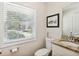 Bright bathroom features a window, granite counters, framed artwork, and a decorative reed diffuser at 1155 Moores Mill Nw Rd, Atlanta, GA 30327