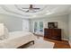 Bedroom with tray ceiling, ceiling fan, French doors to balcony, and large dresser at 1155 Moores Mill Nw Rd, Atlanta, GA 30327