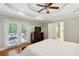Bedroom featuring tray ceilings, a ceiling fan, and French doors leading to the outdoor balcony at 1155 Moores Mill Nw Rd, Atlanta, GA 30327