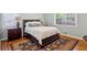 Well-lit bedroom with hardwood floors, oriental rug, two windows, and classic furniture at 1155 Moores Mill Nw Rd, Atlanta, GA 30327