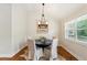 Cozy dining room with hardwood floors, modern lighting, and a view of the outdoors at 1155 Moores Mill Nw Rd, Atlanta, GA 30327