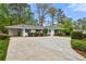 Ranch home featuring large driveway, white paint, and manicured shrubs at 1155 Moores Mill Nw Rd, Atlanta, GA 30327