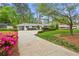 Well-kept ranch home featuring a driveway, vibrant azaleas, and meticulous landscaping at 1155 Moores Mill Nw Rd, Atlanta, GA 30327
