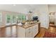 Open kitchen island with double sink overlooking living area and balcony access at 1155 Moores Mill Nw Rd, Atlanta, GA 30327