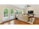 Bright living room with hardwood floors, French doors to balcony, and modern furnishings at 1155 Moores Mill Nw Rd, Atlanta, GA 30327