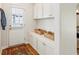 Well-organized mudroom features white cabinetry, woven baskets, and a view of the outdoors through the entry door's window at 1155 Moores Mill Nw Rd, Atlanta, GA 30327