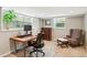 Finished basement area converted into an office with two windows, a desk and chair, and wood floors at 1155 Moores Mill Nw Rd, Atlanta, GA 30327
