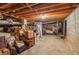 Unfinished basement with exposed beams, boxes, and various stored items at 1155 Moores Mill Nw Rd, Atlanta, GA 30327