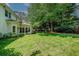 An expansive backyard with lush lawn and mature trees, offering privacy and space for outdoor activities at 1187 Druid Walk, Decatur, GA 30033