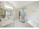 Bright bathroom with double sinks, a large soaking tub, and a separate shower area at 1187 Druid Walk, Decatur, GA 30033