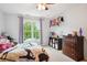 Bright bedroom featuring a ceiling fan, a large window with a view, and neutral-colored walls at 1187 Druid Walk, Decatur, GA 30033