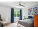 This cozy bedroom has neutral walls, a ceiling fan, a window, and some interesting art at 1187 Druid Walk, Decatur, GA 30033