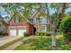 Lovely two-story brick home with a well-manicured lawn, mature trees, and a two-car garage at 1187 Druid Walk, Decatur, GA 30033