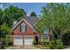 Charming two-story brick home with manicured landscaping and a two-car garage at 1187 Druid Walk, Decatur, GA 30033