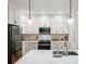 Modern kitchen with white countertops, stainless steel appliances, and pendant lighting at 1187 Druid Walk, Decatur, GA 30033