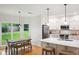Bright kitchen with white cabinets, stainless steel appliances, hardwood floors and an eat-in area at 1187 Druid Walk, Decatur, GA 30033