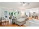 Bright and airy living room featuring hardwood floors, a sectional sofa, and access to a sunroom at 1187 Druid Walk, Decatur, GA 30033