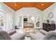 Open living room featuring slate floors, a wood plank ceiling, and glass doors leading to the sunroom at 1187 Druid Walk, Decatur, GA 30033