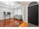 Bright living room featuring hardwood floors, a modern light fixture, and a stylish gray couch at 1187 Druid Walk, Decatur, GA 30033
