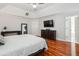 Spacious main bedroom with hardwood floors, a ceiling fan, a TV and an ensuite bath at 1187 Druid Walk, Decatur, GA 30033