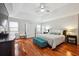 The main bedroom includes hardwood floors, a ceiling fan, and a large window with plenty of natural light at 1187 Druid Walk, Decatur, GA 30033
