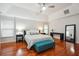 Spacious main bedroom featuring hardwood floors, a ceiling fan, and ample natural light from the large window at 1187 Druid Walk, Decatur, GA 30033