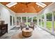 Bright sunroom featuring slate floors, a wood plank ceiling, and multiple windows offering backyard views at 1187 Druid Walk, Decatur, GA 30033