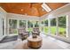 Bright sunroom featuring slate floors, a wood plank ceiling, and multiple windows offering backyard views at 1187 Druid Walk, Decatur, GA 30033