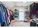 Well-organized walk-in closet with plenty of hanging space, shelving, and a window for natural light at 1187 Druid Walk, Decatur, GA 30033